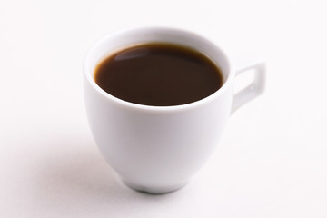 Cup of black strong coffee for breakfast on light background