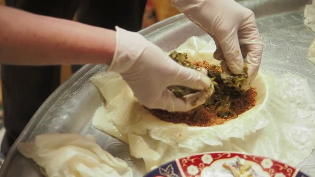 Chef assembling a classic Moriocan dish, a chicken & almond pastillas in Fez, Morocco