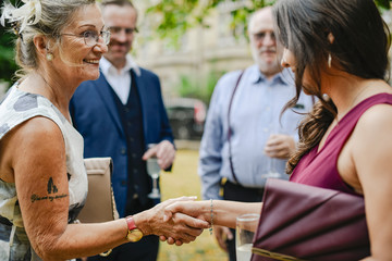 Mother of the bride greeting the guests at a wedding party
