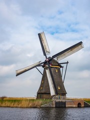 Netherlands rural landscape with windmills and canal