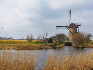 Netherlands rural landscape with windmills and canal