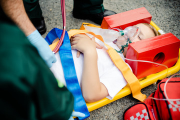Paramedic team rescuing a young critical patient - Powered by Adobe