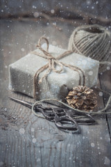 Gift box wrapped linen cloth and decorated with cord, jute, christmas decoration. Drawn Snowfall