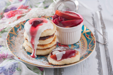 Homemade cottage cheese pancakes with berry-fruit sauce and sour