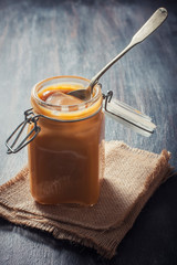 Homemade caramel sauce in a glass jar