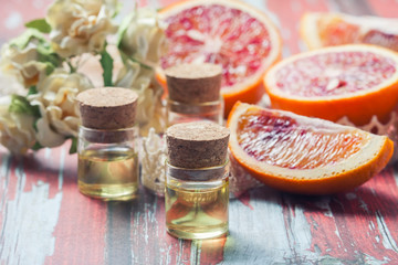 Essential oil citrus  with orange slices,  in glass bottle on ol