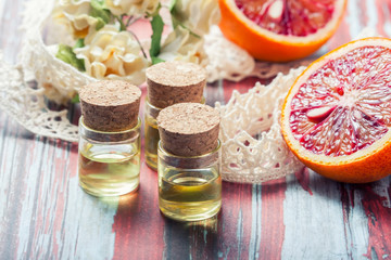 Essential oil citrus  with orange slices,  in glass bottle on ol