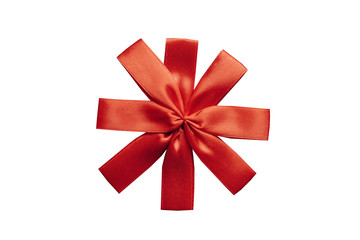 Red bow on gift box top view isolated on white background.