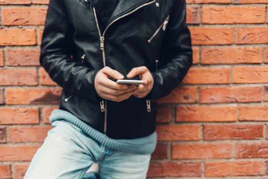 Teenage boy holding a cell phone in Sweden