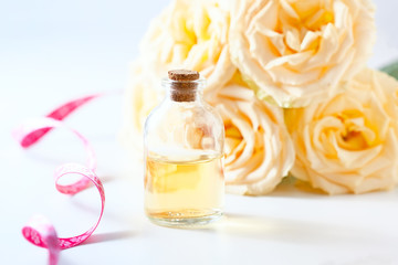 Glass jar with rose water and aromatherapy, copy space for text.