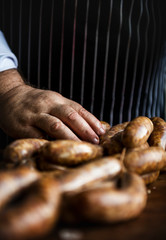 Butcher with smoked sausages on a string