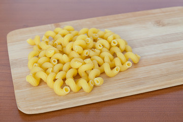 Figured pasta on a wooden board