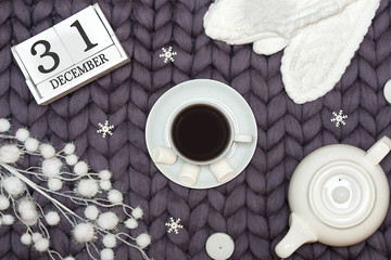 Christmas decor on a woolen blanket. A cup of hot coffee with marshmallows.Xmas card.New Year, holidays concept.