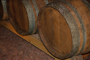 Old  oak wine barrel in wine cellar, this type of barrel used as traditional aging methods in winemaking.