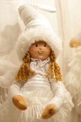 Festive Christmas decoration with a wooden and fabric doll.