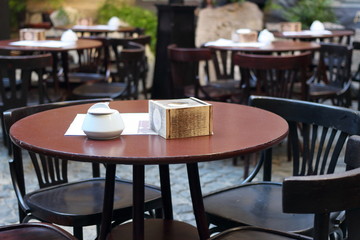 Sugar bowl and napkin holder on table in cafe, vintage style