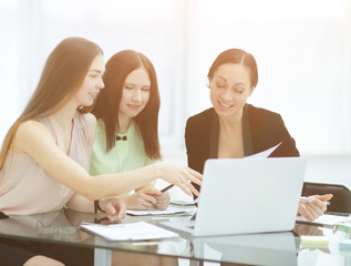 three business women discussing work issues in the office