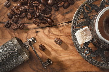 Fototapeta na wymiar Turkish coffee cup and coffee beans on wooden ground
