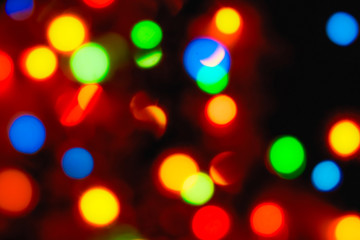 Christmas lights. Blurred festive background for a New Year's design. Winter holidays. Bokeh. Bright juicy colors.