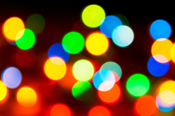 Christmas lights. Blurred festive background for a New Year's design. Winter holidays. Bokeh. Bright juicy colors.