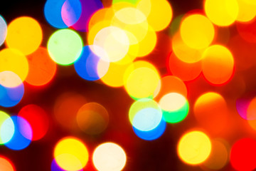 Christmas lights. Blurred festive background for a New Year's design. Winter holidays. Bokeh. Bright juicy colors.