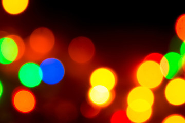 Christmas lights. Blurred festive background for a New Year's design. Winter holidays. Bokeh. Bright juicy colors.