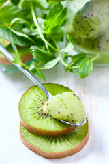 Fototapeta na wymiar Homemade fruit popsicle with kiwi and mint.
