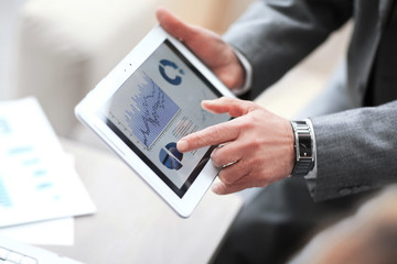 businessman hands on a digital tablet with finansowym schedule