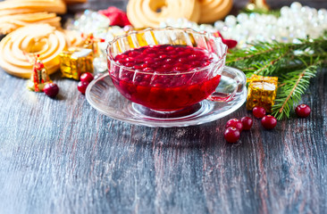 Christmas hot cranberry tea, cookies and orange slices, on dark background.