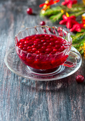 Christmas hot cranberry tea, cookies and orange slices, on dark background.
