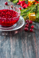 Christmas hot cranberry tea, cookies and orange slices, on dark background.