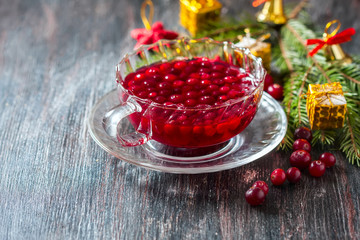 Christmas hot cranberry tea, cookies and orange slices, on dark background.
