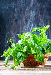 Juicy, fresh, aromatic green mint on the wooden table