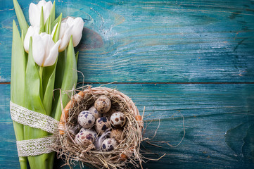 easter composition consists of a white tulips, quail eggs