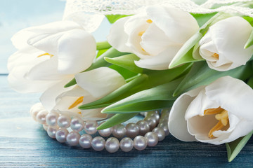 Fototapeta na wymiar bouquet of white tulips on a wooden background
