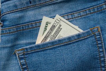 Jeans pocket with one hundred dollars banknotes
