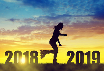 Silhouette the girl on roller skates at sunset. Forward to the New Year 2019.