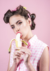 banana dieting. pinup girl with fashion hair. retro woman eating banana. pin up woman with trendy makeup. pretty girl in vintage style. Join healthy lifestyle