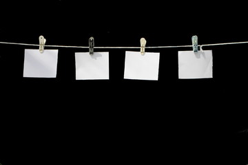 White hanger on a rope on a black background.