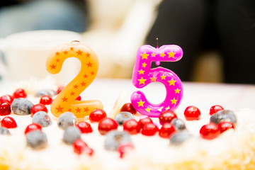 The cut-off cake with candles in figures