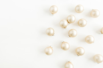 Christmas pattern with golden decoration balls on white background. Flat lay, top view. Blog hero header.