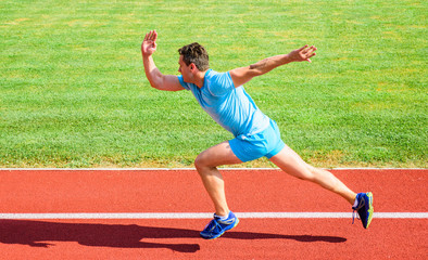 Boost speed concept. Man athlete runner push off starting position stadium path sunny day. How to...