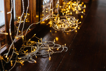 Warm Christmas lights on the window on a blurred background