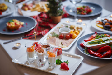 Beautifully served table in a restaurant with lots of salads, appetizers, desserts