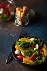 Salad with tomatoes, cucumbers, cheese and lettuce