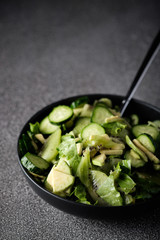 Green salad with kiwi, cucumber and avocado