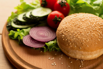 Ingredients for vegan burger with champignons, onion, lettuce, onion and tomatoes, close up