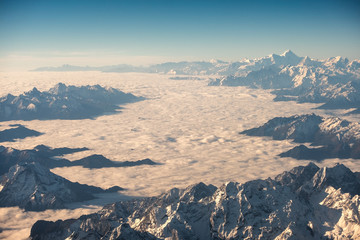 Above of cloudy cluster with rocky mountain