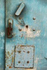 Texture of surface of rusty metal garage with cracked paint