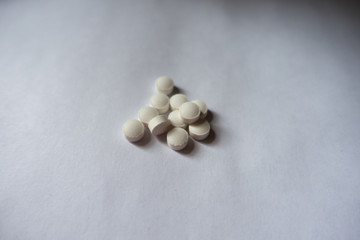 Some small white round vitamin K tablets